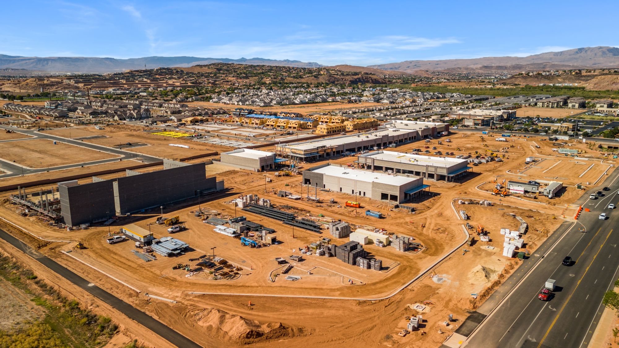 Aerial view across The Paseo construction site toward the surrounding St. George neighborhoods