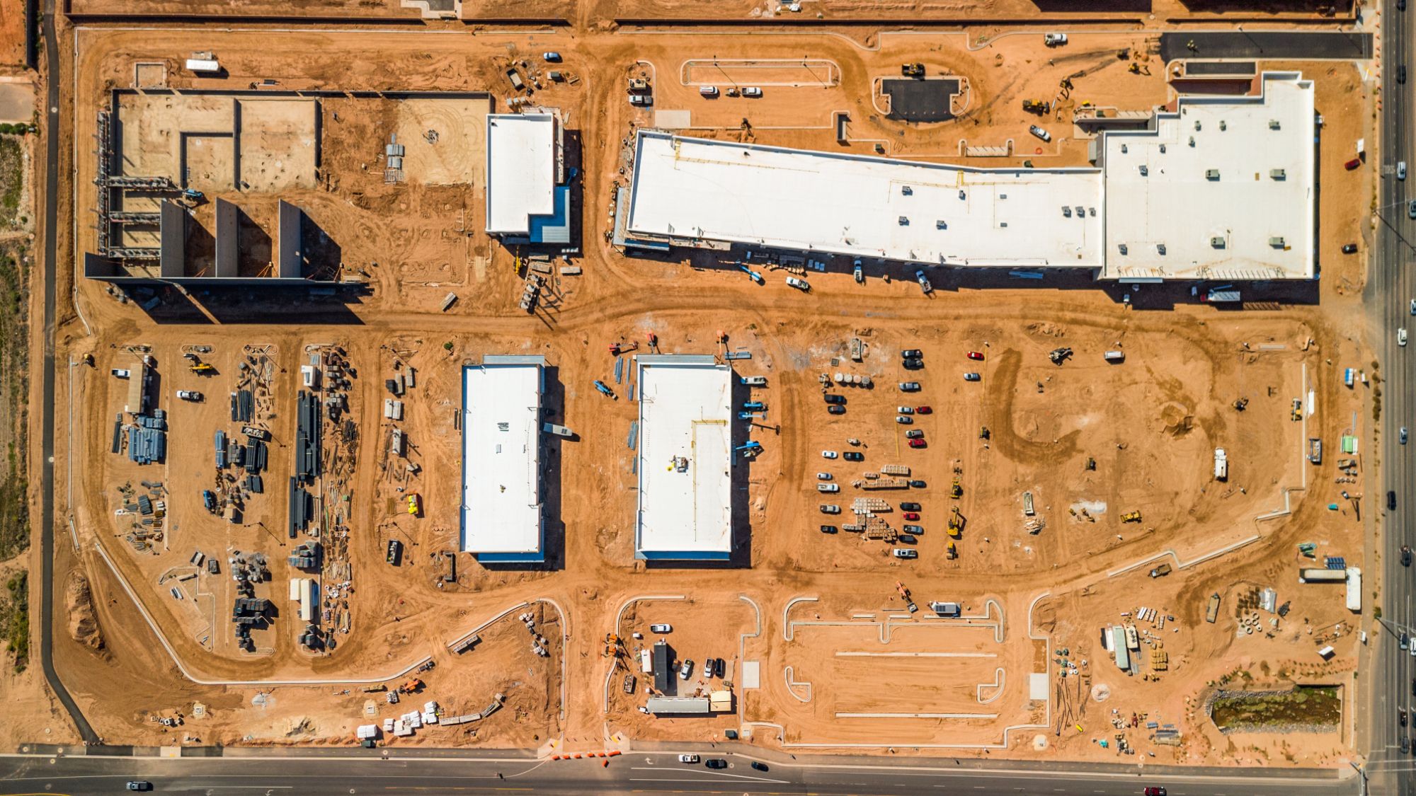 Overhead view of The Paseo construction site showing the building pads, drive aisles and parking layout